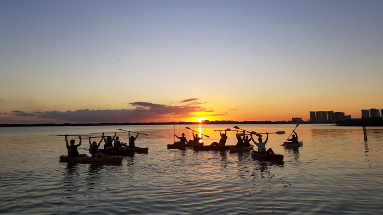 Kayakers having fun in the sunset