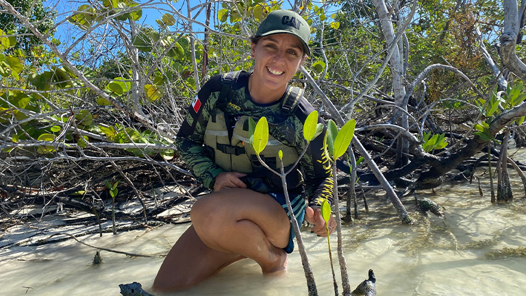 Sam from conexión nativa with baby mangrove